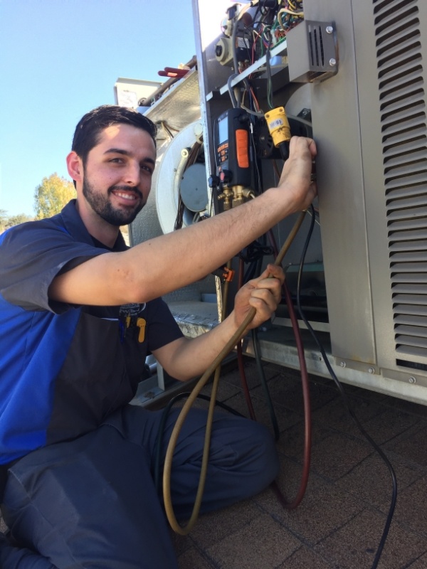 Technician working on a AC unit