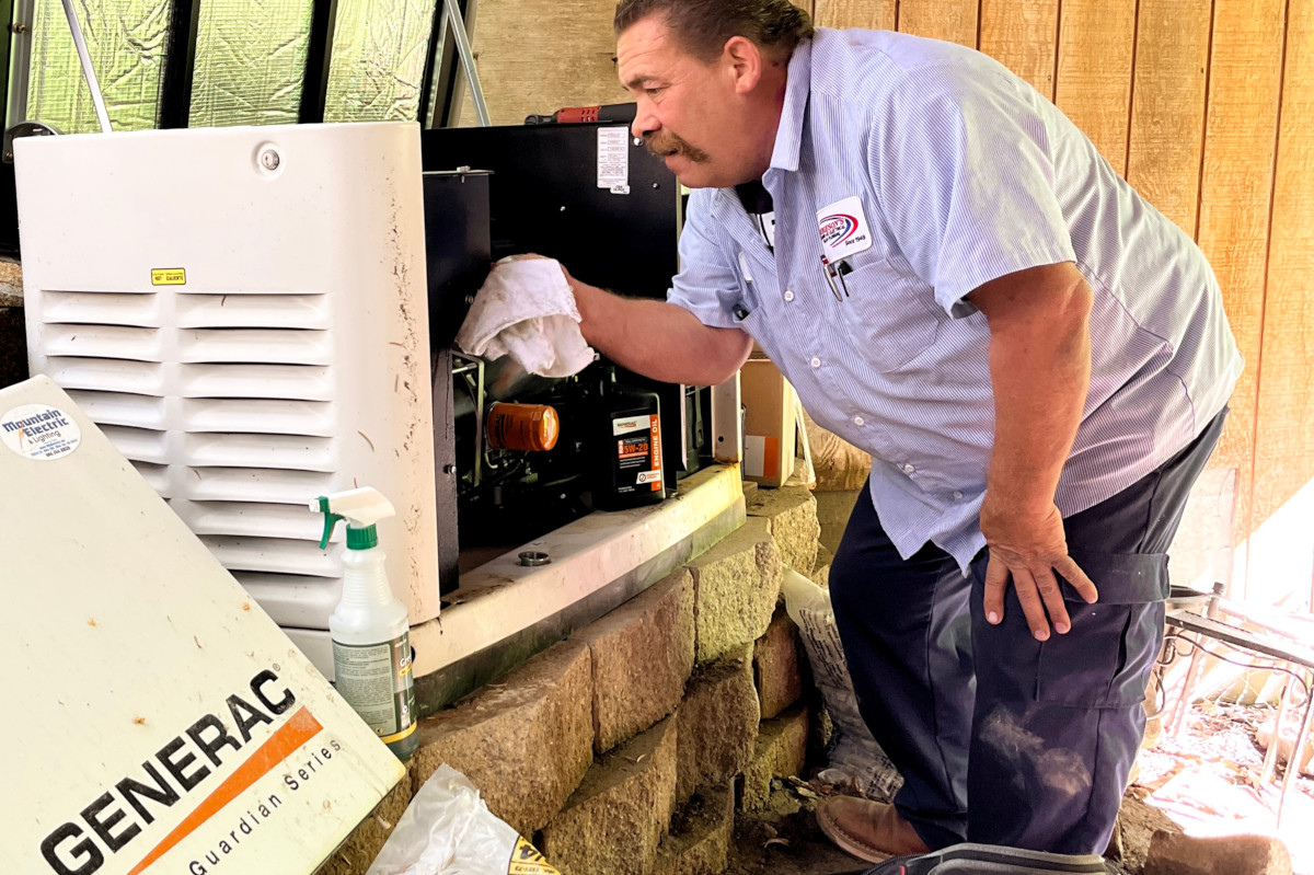 Burgeson's employee checking a generator