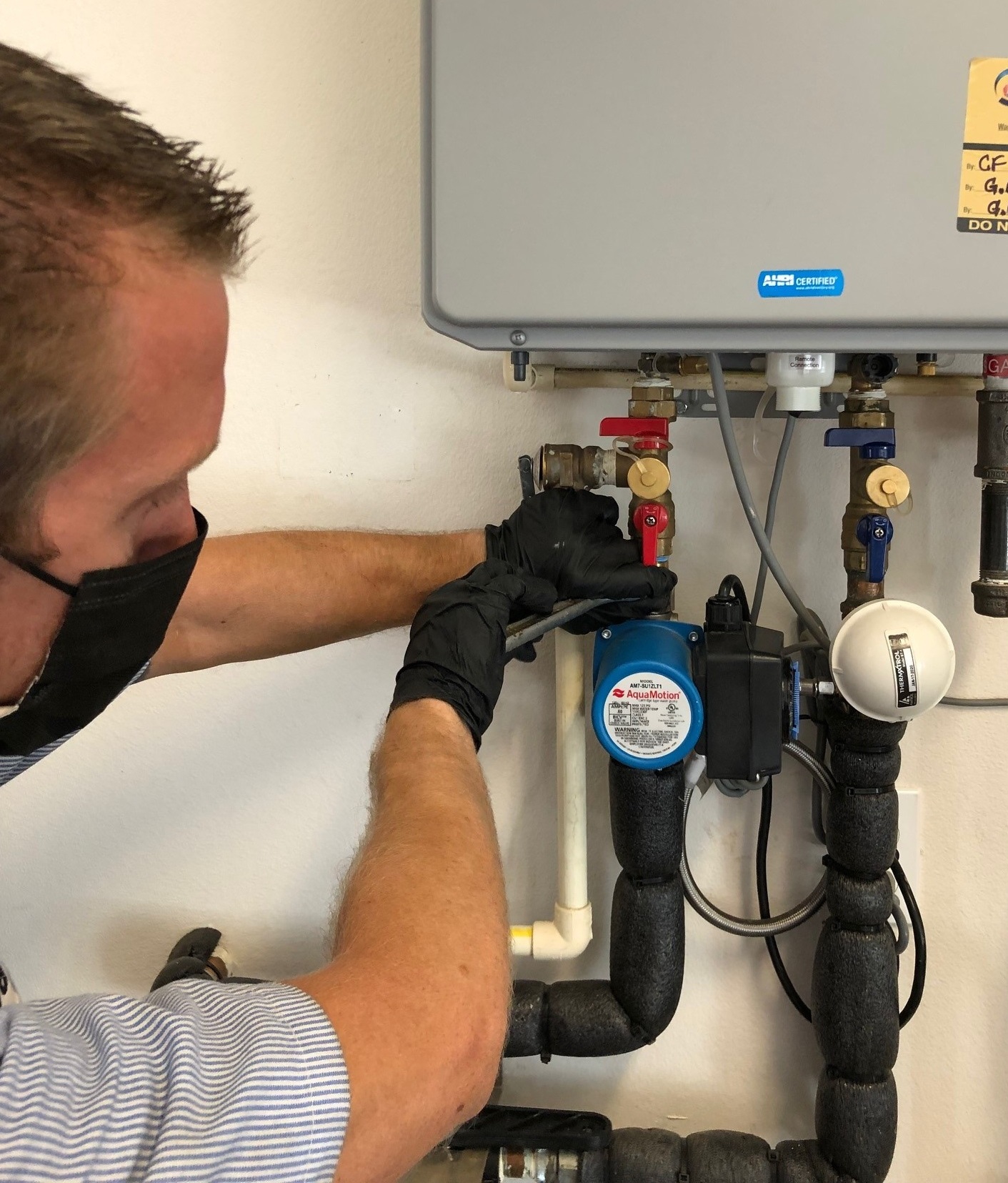 Technician working on tankless water heater 