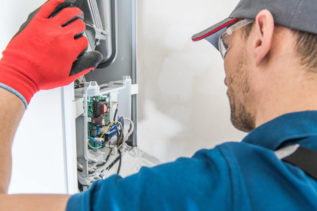 Technician maintaining a furnace