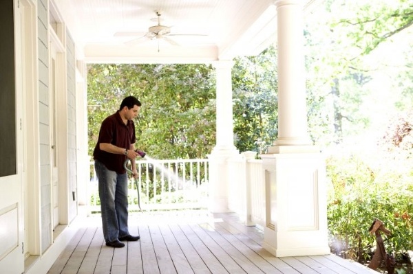 Homeowner cleaning off his porch